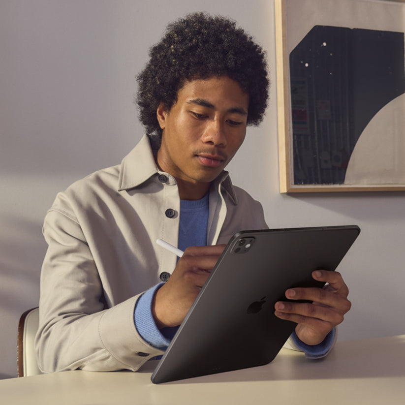 Man writing on screen with Apple Pencil on Apple iPad Pro M5 13-inch 2TB Nano-texture Space Black at Tradeline.